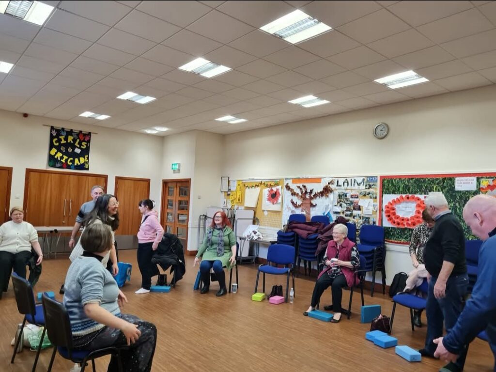 People meeting and taking part in activities in the hall.
